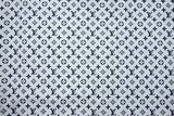 Black Louis Vuitton monogram print on white cotton fabric